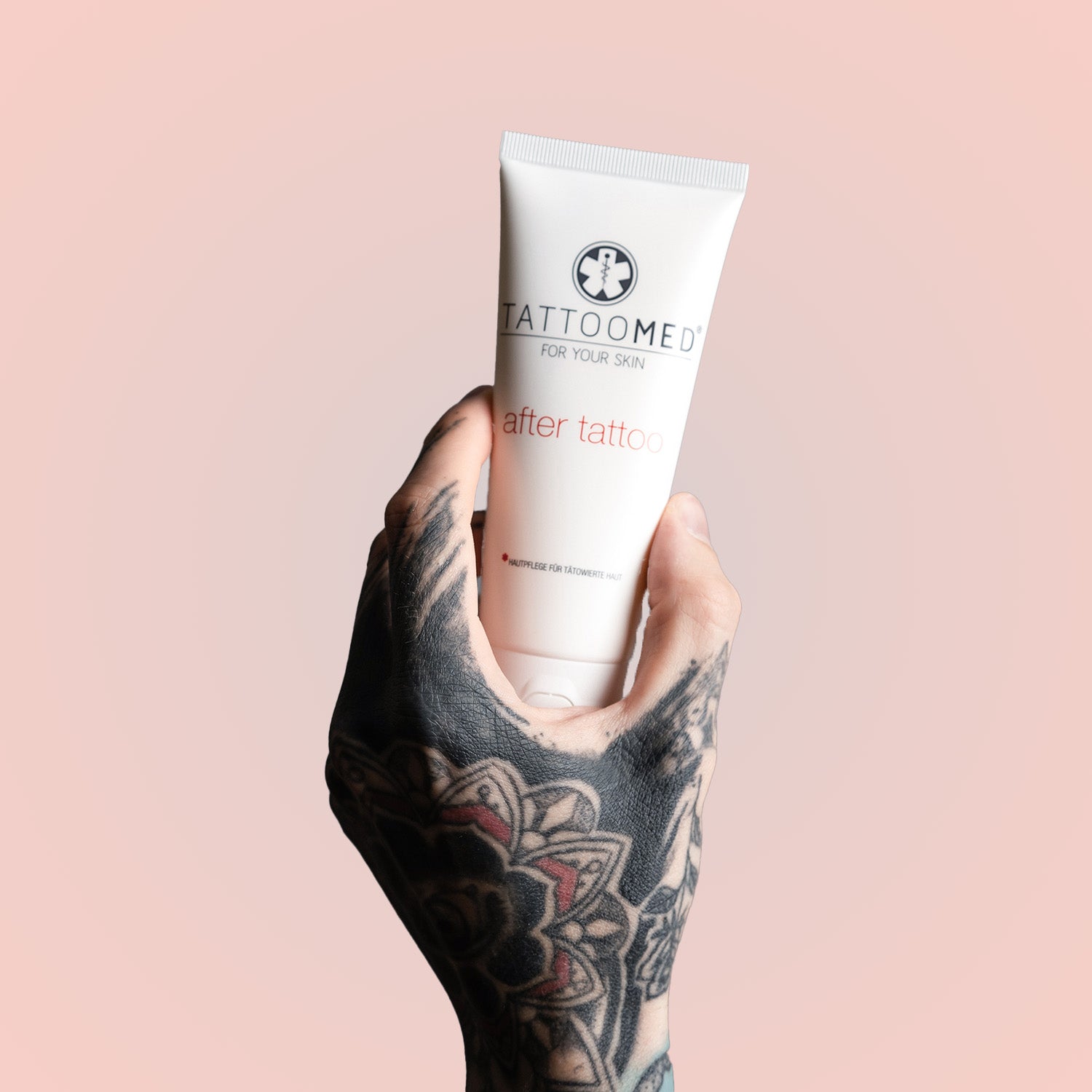 TattooMed After Tattoo in einer tätowierten Hand